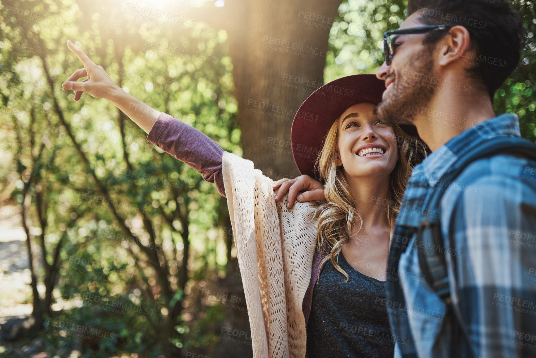 Buy stock photo Couple, pointing and happy in forest on adventure with smile to explore nature, bonding and love in Thailand. People, relationship and date in woods on trip or journey for holiday, break and fun