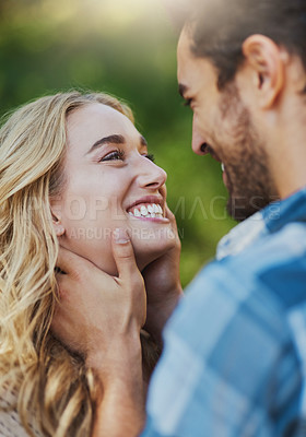 Buy stock photo Shot of an affectionate young couple having a romantic moment outdoors