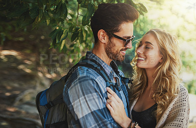 Buy stock photo Shot of a happy young couple spending time together in nature