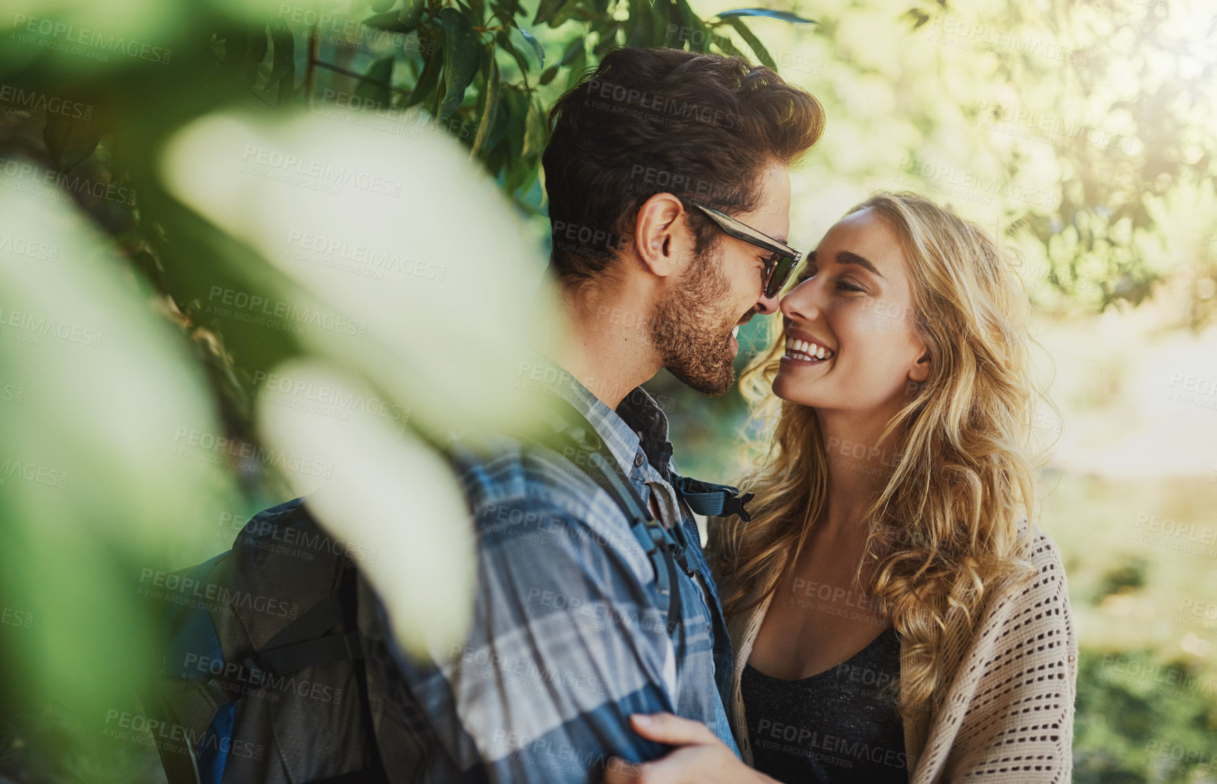 Buy stock photo Shot of a happy young couple spending time together in nature