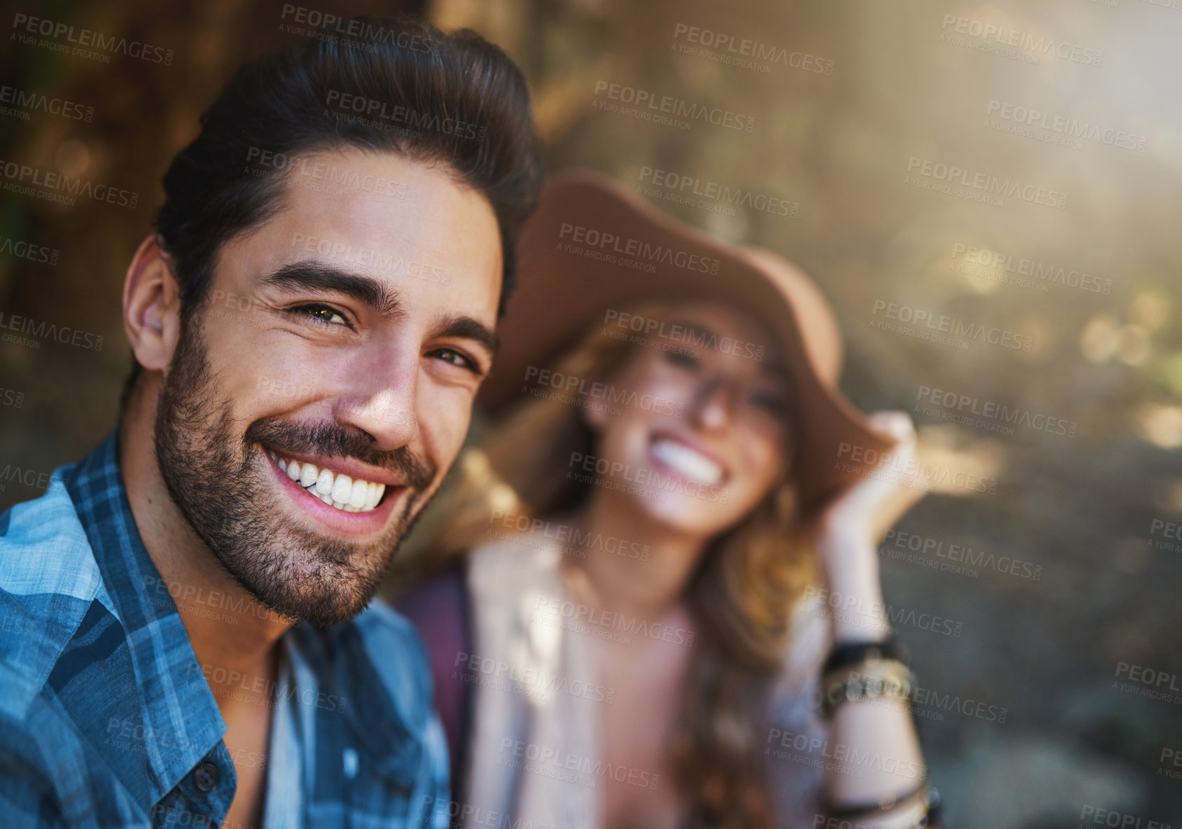 Buy stock photo Shot of a happy young couple spending time together in nature