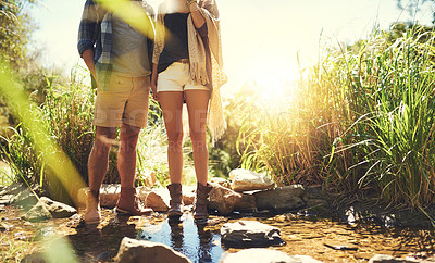 Buy stock photo Couple, holding hands and hiking legs in nature, spouse support and explore woods together. People, walking and forest stream for holiday travel adventure, partnership trust and countryside trekking