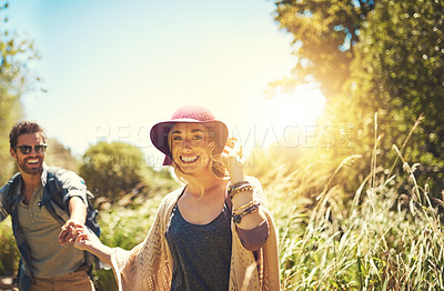 Buy stock photo Shot of a happy young couple exploring nature together