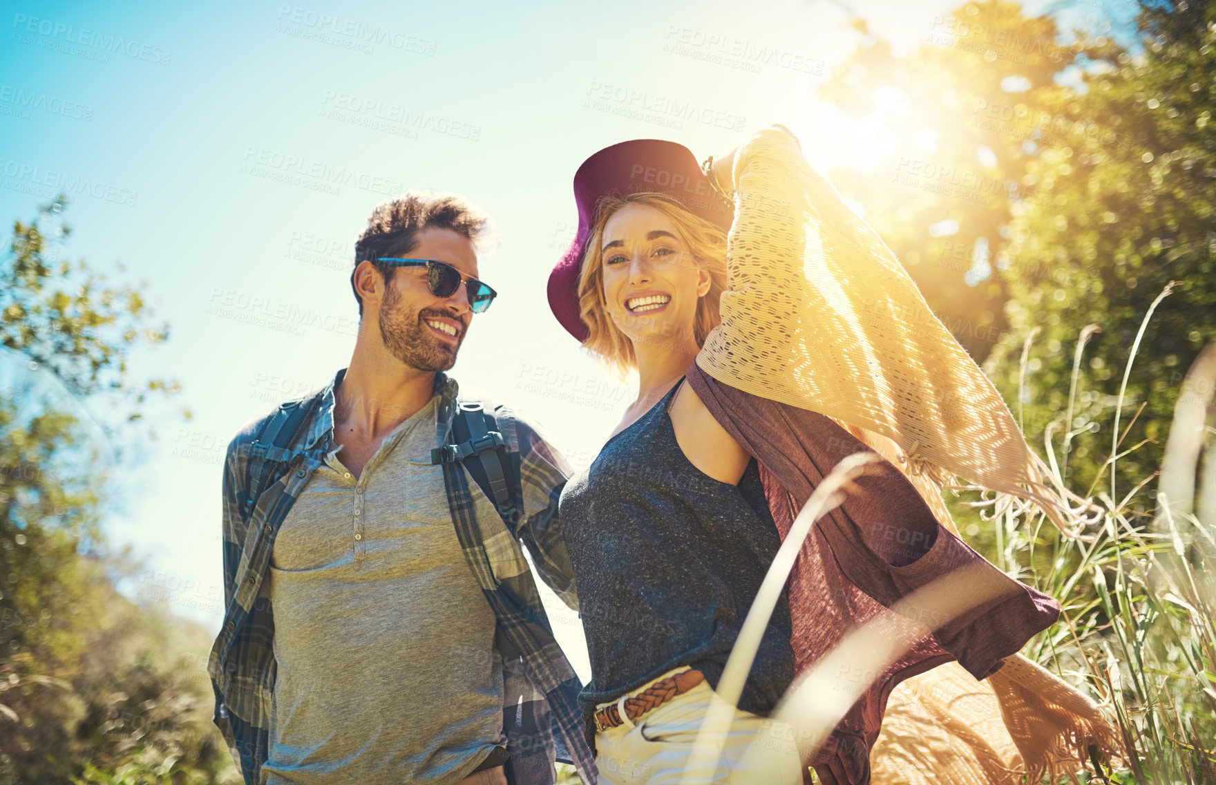 Buy stock photo Shot of a happy young couple exploring nature together