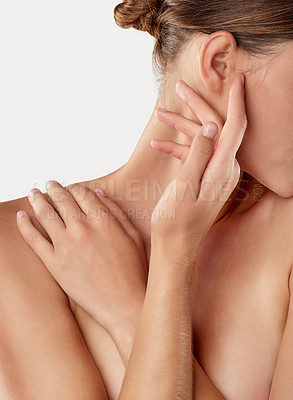 Buy stock photo Closeup studio shot of a beautiful young woman caressing her skin