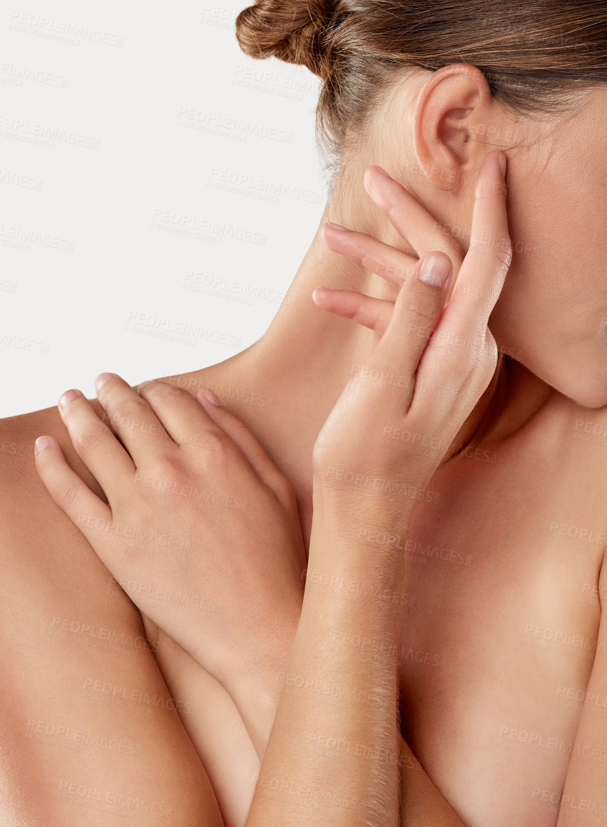 Buy stock photo Closeup studio shot of a beautiful young woman caressing her skin