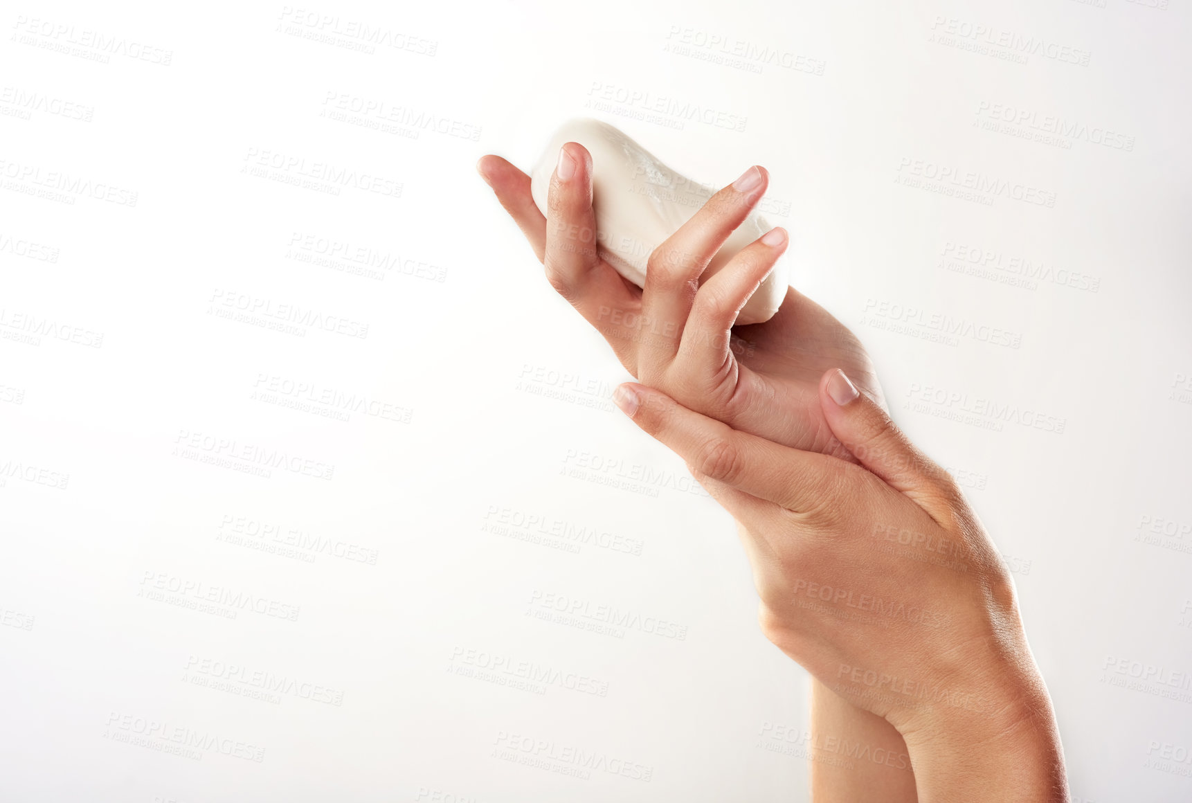 Buy stock photo Closeup studio shot of a woman's hands holding a bar of soap