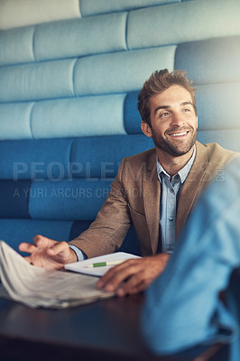 Buy stock photo Shot of a young man having a business meeting in a cafe
