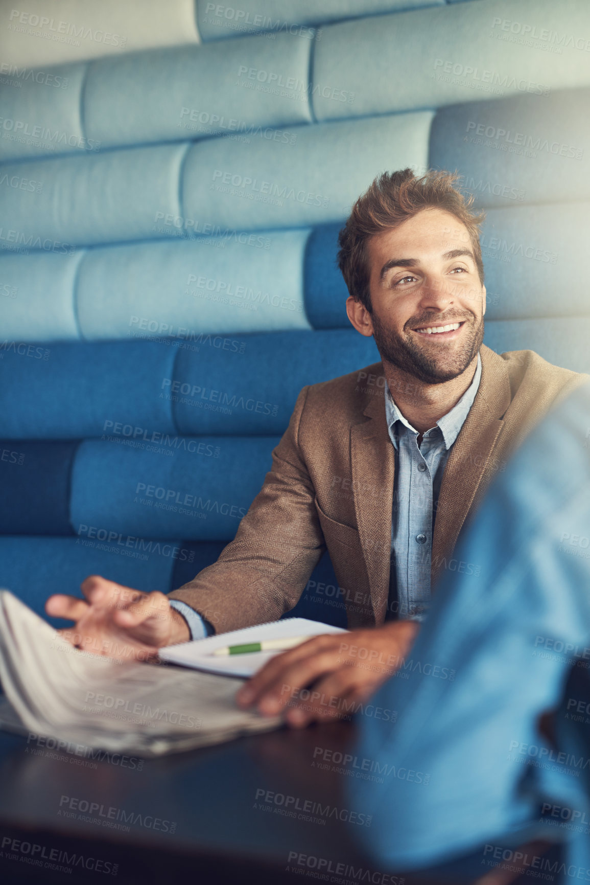 Buy stock photo Shot of a young man having a business meeting in a cafe