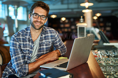 Buy stock photo Portrait of a handsome young man sitting in a cafe using a laptop