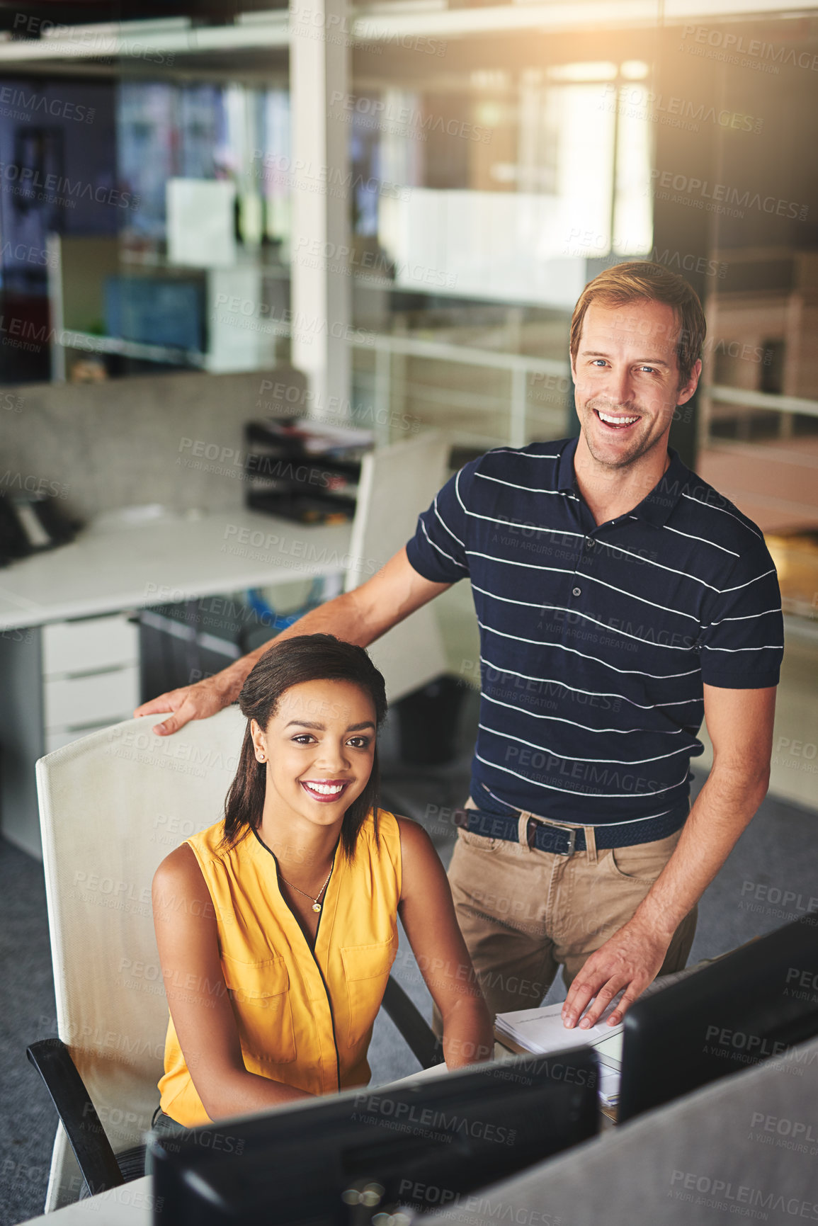 Buy stock photo Portrait of two smiling colleagues working together in an office