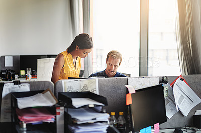 Buy stock photo Shot of two colleagues working together in an office