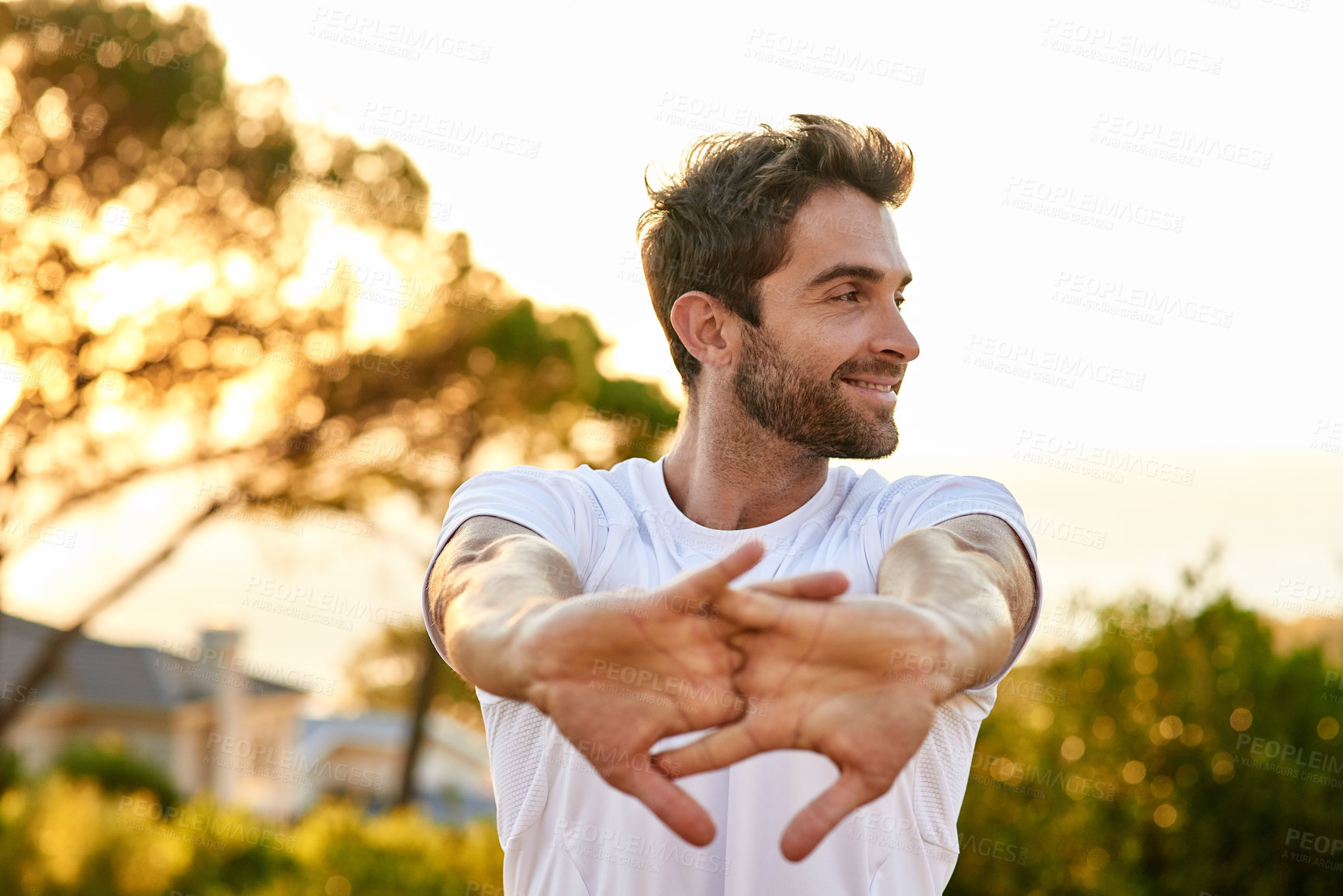Buy stock photo Shot of a man stretching before a run