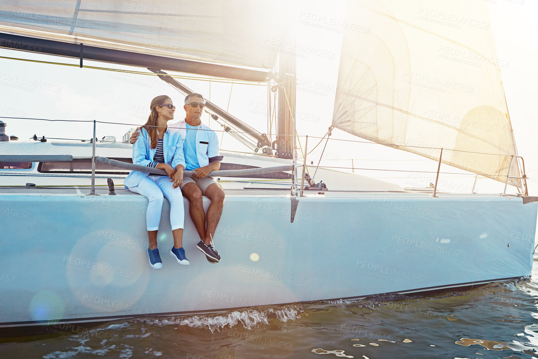 Buy stock photo Yacht, relax and travel with a mature couple sitting on a boat out at sea for love, romance or dating together. Water, summer and ship with a man and woman enjoying a trip on the ocean while bonding