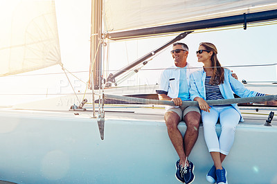 Buy stock photo Shot of a couple enjoying a boat cruise out on the ocean