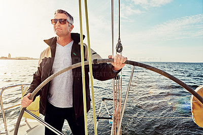 Buy stock photo Shot of a man out on a boat trip alone