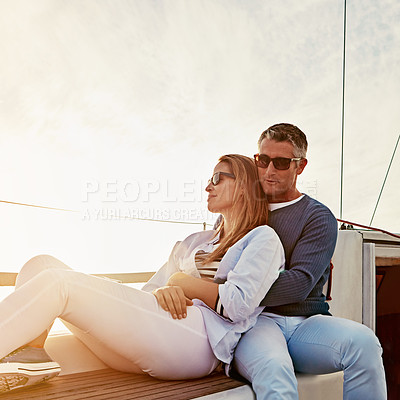 Buy stock photo Shot of a couple enjoying a boat cruise out on the ocean