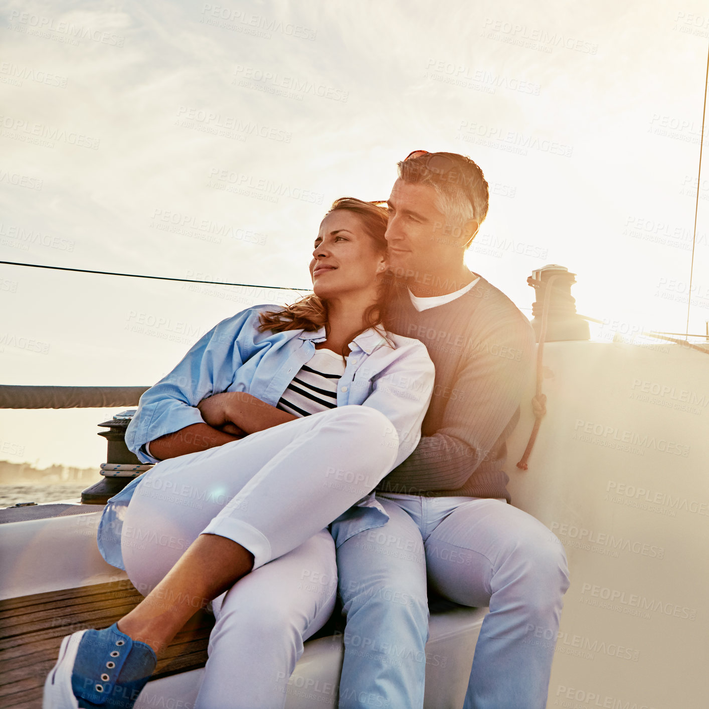 Buy stock photo Shot of a couple enjoying a boat cruise out on the ocean