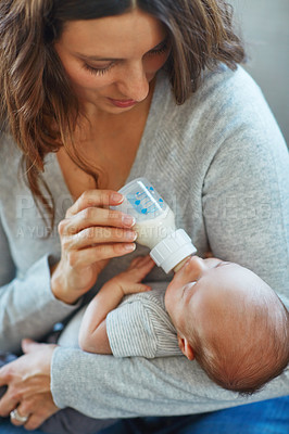 Buy stock photo Shot of a mother feeding her newborn baby