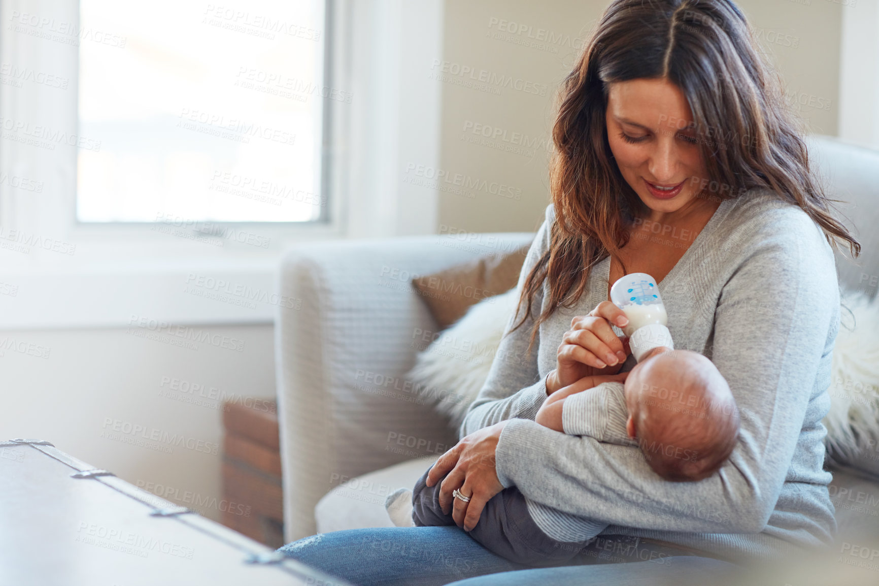 Buy stock photo Shot of a mother feeding her newborn baby