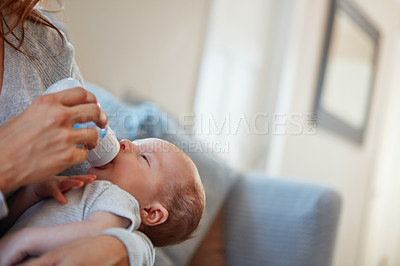 Buy stock photo Shot of a mother feeding her newborn baby