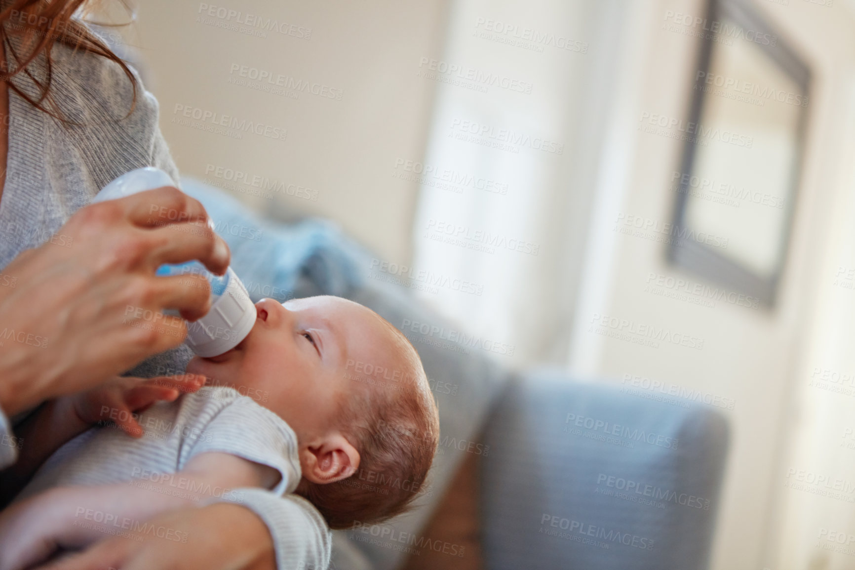 Buy stock photo Shot of a mother feeding her newborn baby