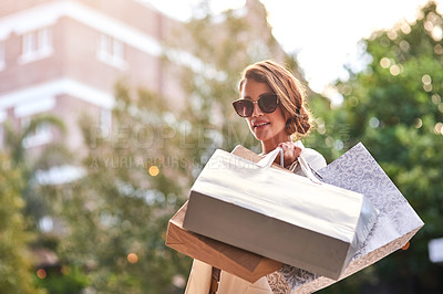 Buy stock photo Shot of a young woman out shopping in the city
