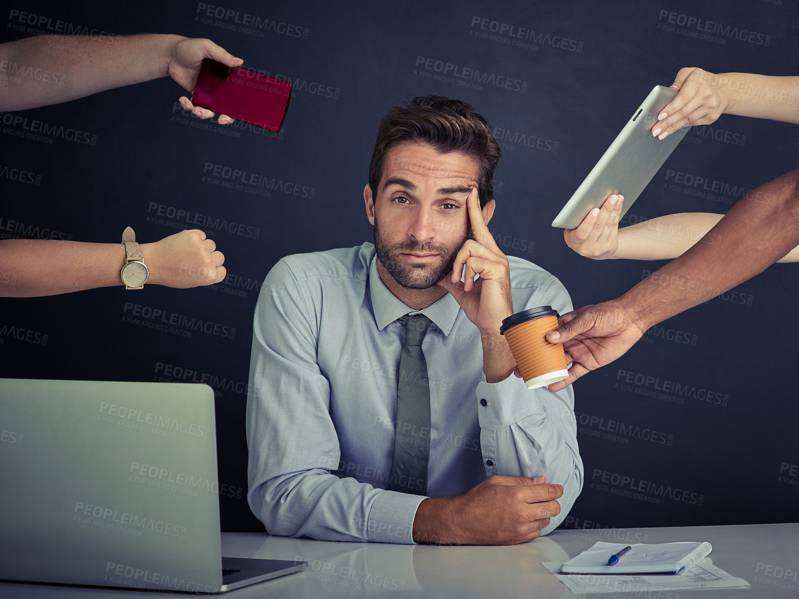 Buy stock photo Portrait of a young corporate businessman sitting at a desk surrounded by hands reaching in with office items