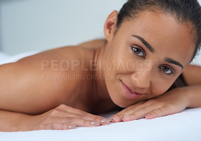 Buy stock photo Portrait of a beautiful young woman relaxing on a massage table at a spa