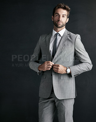 Buy stock photo Studio portrait of a confident young businessman against a black background