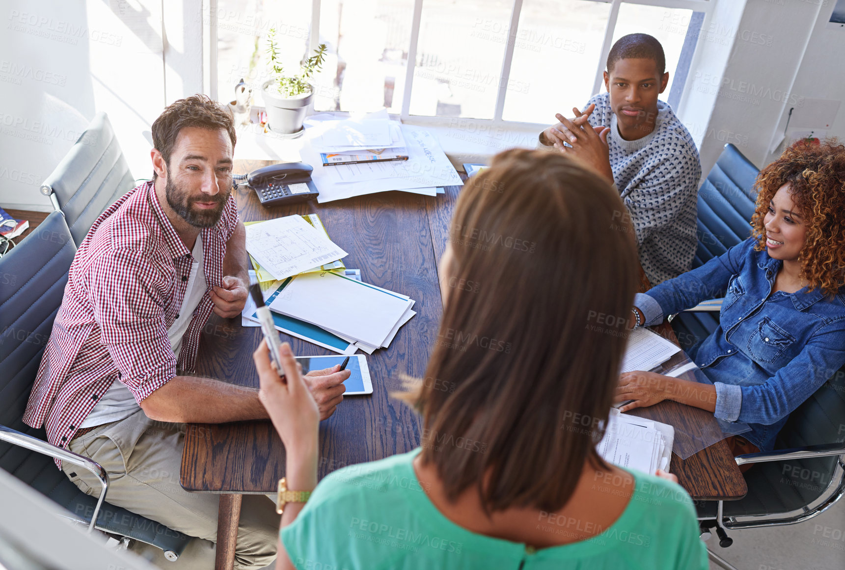 Buy stock photo Shot of a young businesswoman giving a presentation to her design team