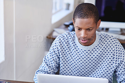Buy stock photo Cropped shot of a young designer working on his laptop