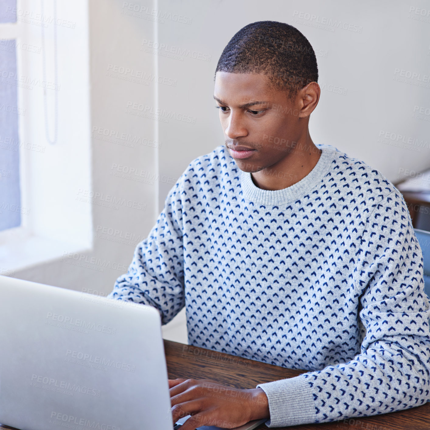 Buy stock photo Cropped shot of a young designer working on his laptop