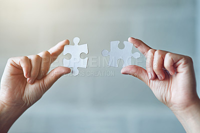 Buy stock photo Cropped shot of a woman holding two puzzle pieces