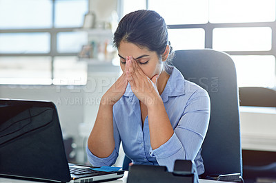 Buy stock photo Shot of a businesswoman experiencing stress at work