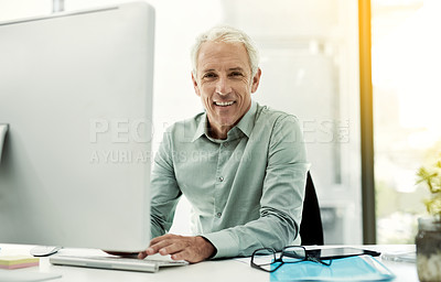 Buy stock photo Portrait of a mature businessman working at his desk in an office
