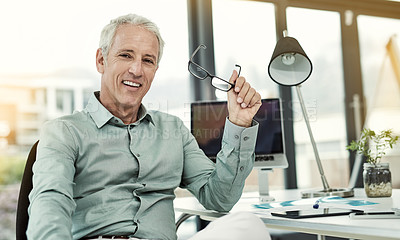 Buy stock photo Portrait of a mature businessman working at his desk in an office