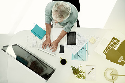 Buy stock photo High angle shot of a mature businessman working on a computer  at his desk in an office