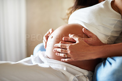Buy stock photo Closeup shot of a husband and wife holding her pregnant belly together