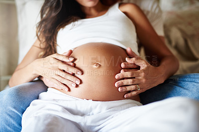 Buy stock photo Closeup shot of a husband and wife holding her pregnant belly together