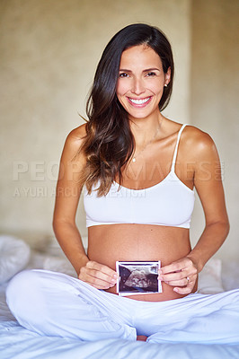 Buy stock photo Portrait shot of a pregnant woman holding a sonogram picture in front of her belly