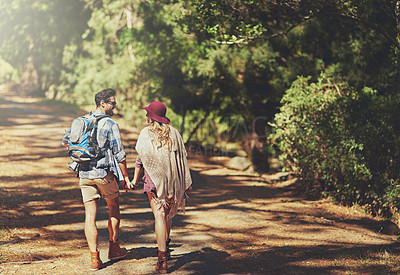 Buy stock photo Rearview shot of an affectionate young couple during a hike