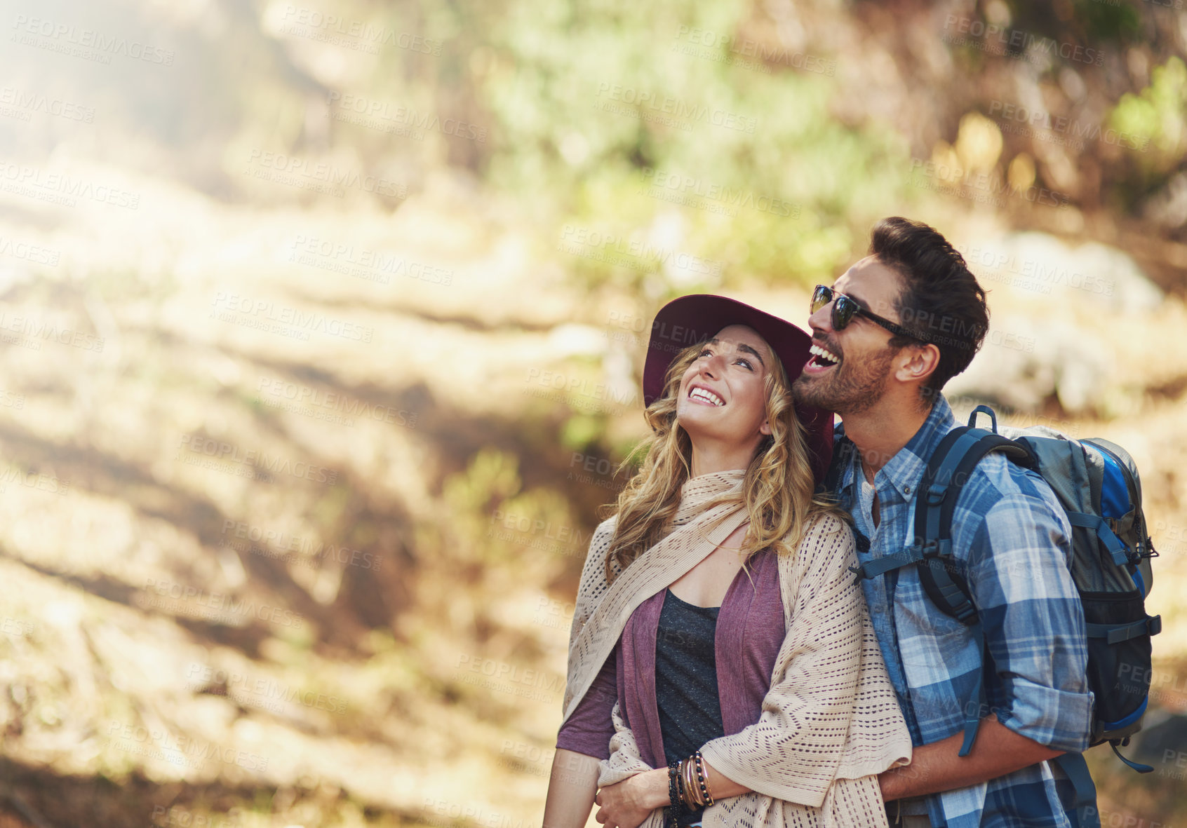 Buy stock photo Hug, couple and happy outdoor for hiking in nature on vacation, together and walking in forest for adventure. Man, woman and smile in woods for explore on travel holiday in New Zealand with space.