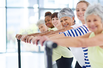 Buy stock photo Shot of a group of women working out indoors