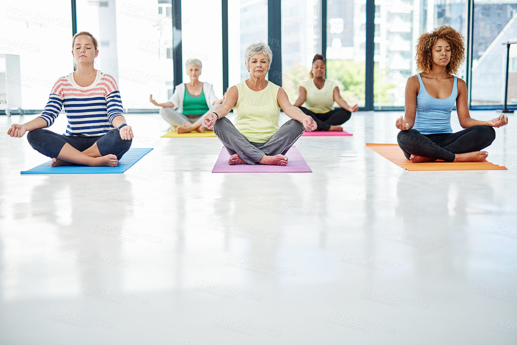 Buy stock photo Shot of a group of women meditating indoors