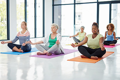 Buy stock photo Shot of a group of women meditating indoors