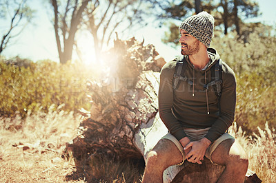 Buy stock photo Cropped shot of a young man taking a break while hiking