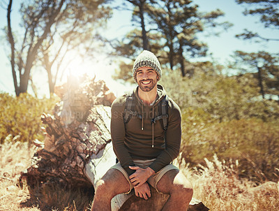 Buy stock photo Cropped portrait of a young man taking a break while hiking