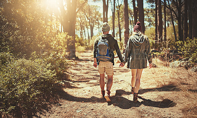 Buy stock photo Back, couple and holding hands for hiking outdoor with backpack, trekking path and travel adventure in nature. People, support and backpacking for fitness, health bonding and cardio care in forest