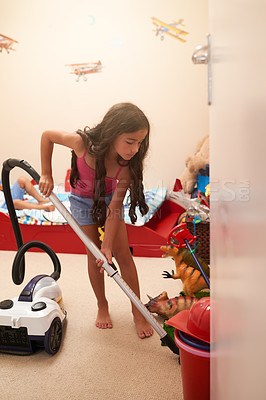 Buy stock photo Girl, kid and cleaning bedroom with vacuum, learning housekeeping with chores and responsibility in childhood. Tidy up mess, independent and development with young child and housework routine at home